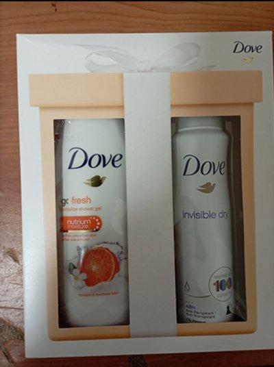 Bílo-oranžová krabička s deodorantem ve spreji a sprchovým gelem Dove