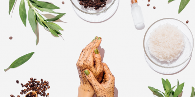 Žena si aplikuje kávový peeling na ruce