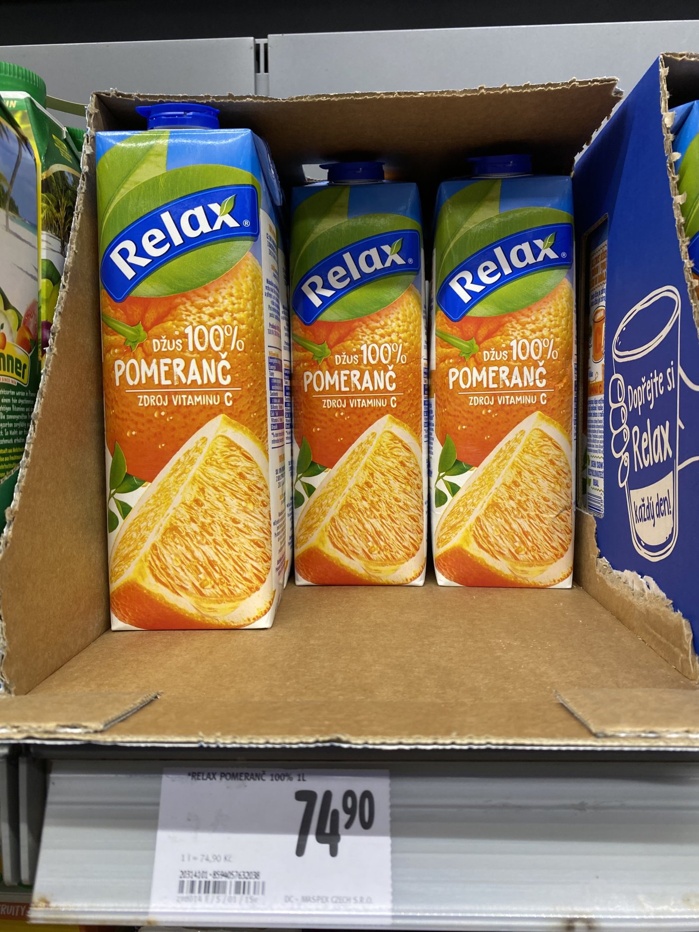 Pomerančové džusy v regálu supermarketu
