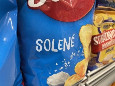 Solené brambůrky v regálu supermarketu