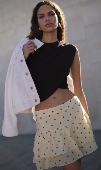 Modelka v puntíkované sukni a černém topu