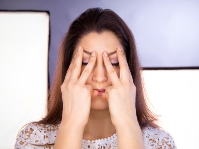 Žena drží ruce na svém obličeji