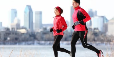 Muž a žena běží v zimním městě