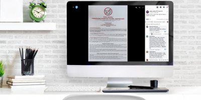 Monitor na stole v pracovně, na kterém je příspěvek, který se šíří na sociálních sítích a není pravdivý 