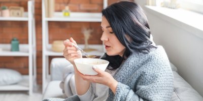 Žena je zabalená do deky jí polévku