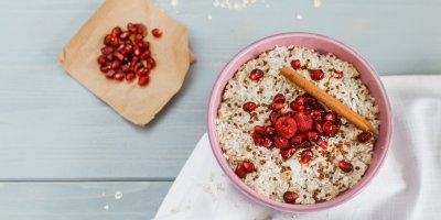 Kaše z quinoy ozdobená granátovým jablkem a malinami