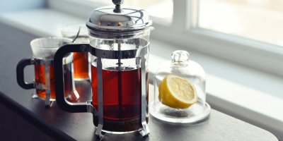 Čaj ve french pressu a v hrnečcích, půlka citronu