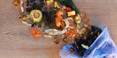 Zbytky jídla vysypané z odpadkového koše