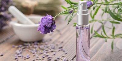 Levandulová voda v lahvičce, v pozadí hmoždíř a levandule