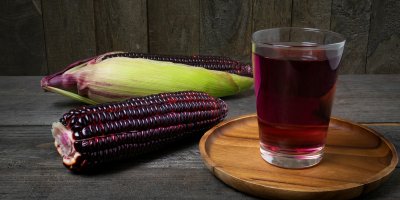 Fialová kukuřice a sklenice fialové šťávy