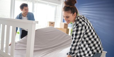 Muž a žena sundavají matraci z postele