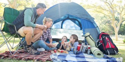 Rodina svačí před stanem