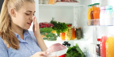 Žena si zakrývá nos před zapáchajícím masem