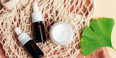 Dvě lahvičky, krém a list ginkgo biloba na síťovce