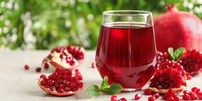 Nakrájené granátové jablko a sklenice se šťávou z něj