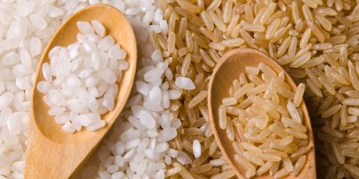 Bílá a hnědá rýže na dřevěných lžičkách