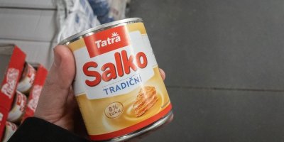 Ruka, držící plechovku salka v obchodě