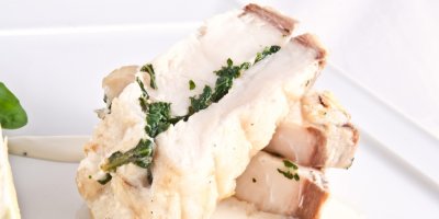 Několik kousků ryby, naservírované na bílém talíři