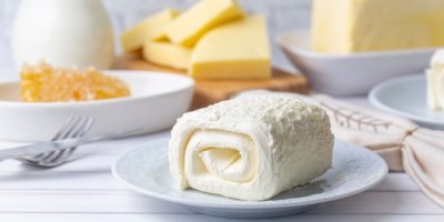 Produkt podobný máslu na talířku, okolo je máslo