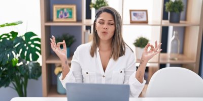 Žena medituje před notebookem