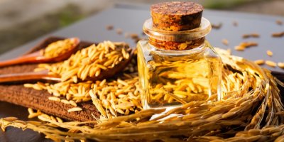 Lahvička rýžového oleje vedle rýžových otrub