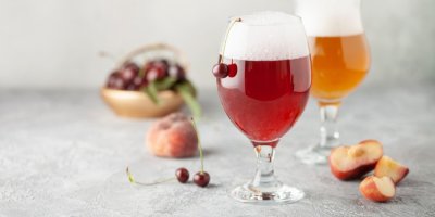 Radlery ve sklenici a ovoce okolo