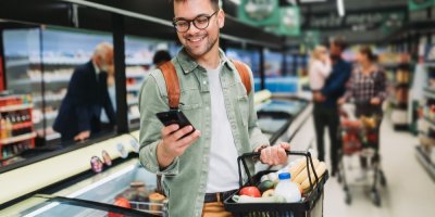 Zákazník supermarketu s plným nákupním košíkem