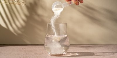 Sypání kolagenu do sklenice s vodou