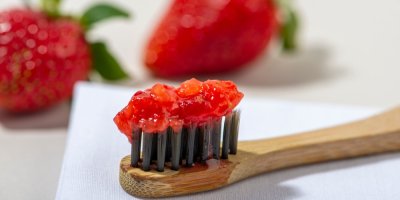 Kartáček s doma vyrobenou jahodovou zubní pastou, jahody mají mírné bělicí účinky