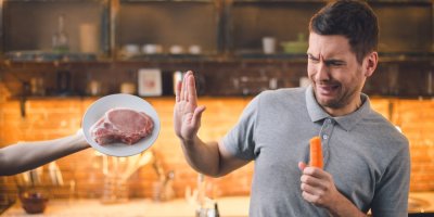 Muž odmítá nabízené vepřové a drží v ruce mrkev