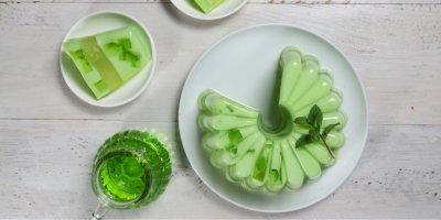 Zelený vrstvený pudink na keramickém talíři