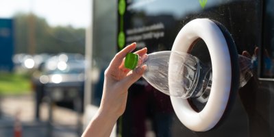 Dávání plastové lahve do kontejneru