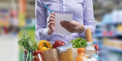 Žena s nákupním seznamem v obchodě