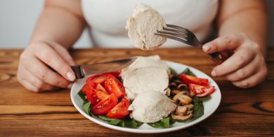 Žena jí dietní oběd s kuřetem