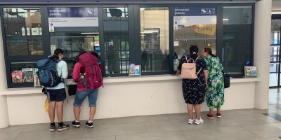 Lidé si kupují jízdenky u výdejních oken Českých drah.