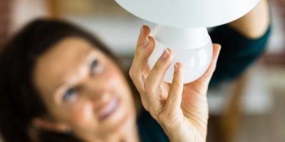 Žena vyměňuje žárovku