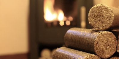 Brikety naskládané na sobě, v pozadí krb