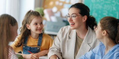 Žena v brýlích a okolo 3 děti