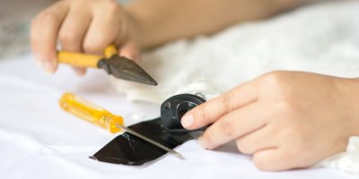 Ruce kleštěmi odstraňuje bezpečnostní čip