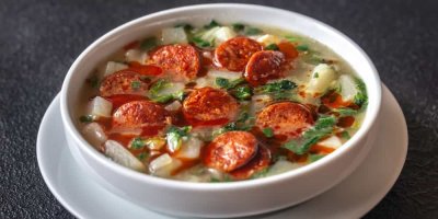 Polévka s klobásou v bílém talíři