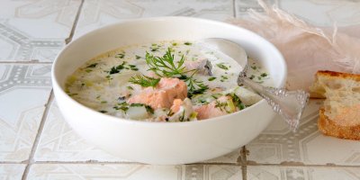 Lososová polévka v talíři, vedle chléb