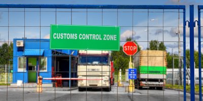 Nákladní auta projíždějí bezpečnostní kontrolou logistického areálu