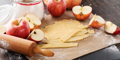 Nakrájená jablka, těsto a vál