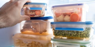 Muž ukládá jídlo v krabičce do lednice