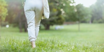 Žena kráčí po trávníku