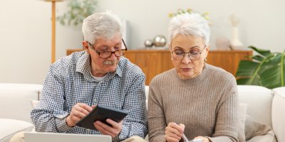 Dva senioři sedí na gauči