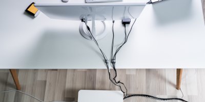 Počítač, ze kterého jsou kabely, na stole