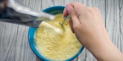 Člověk připravuje dětskou instantní kaši