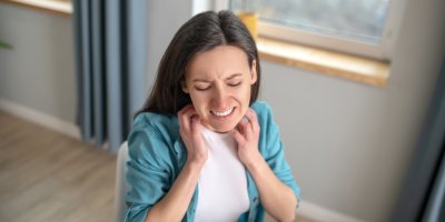 Žena se škrábe na krku