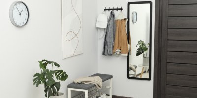 Předsíň se zrcadlem, tmavými dveřmi a lavicí